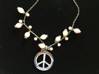 pink acrylic peace sign pendant on adjustable silvertone necklace