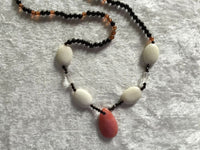 natural rodonite gemstone faceted teardrop pendant on acrylic beaded necklace