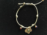 green adjustable bracelet with gold cz butterfly charm